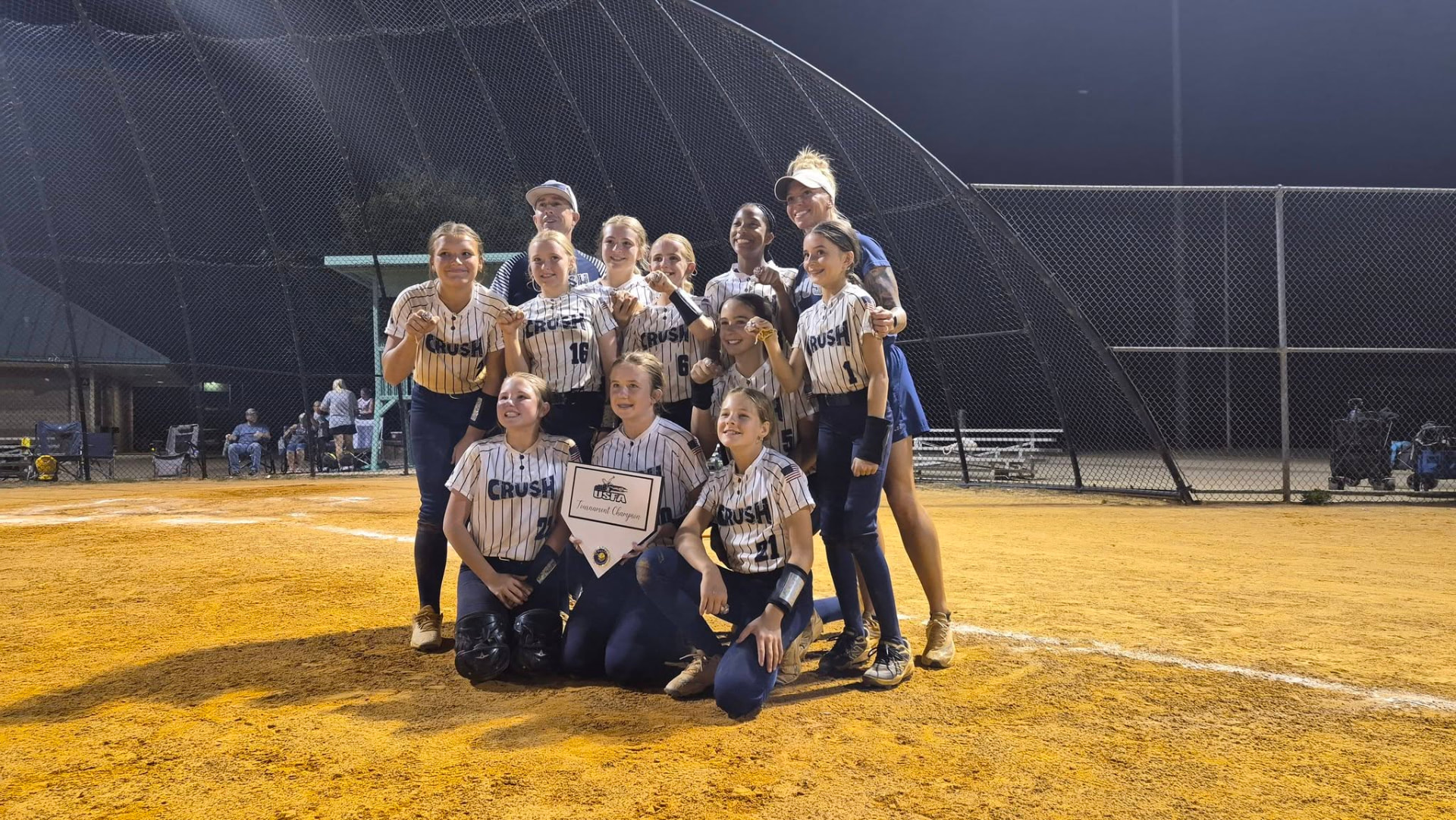 West Cobb Crush 2032 team celebrating a USFA tournament championship under the lights